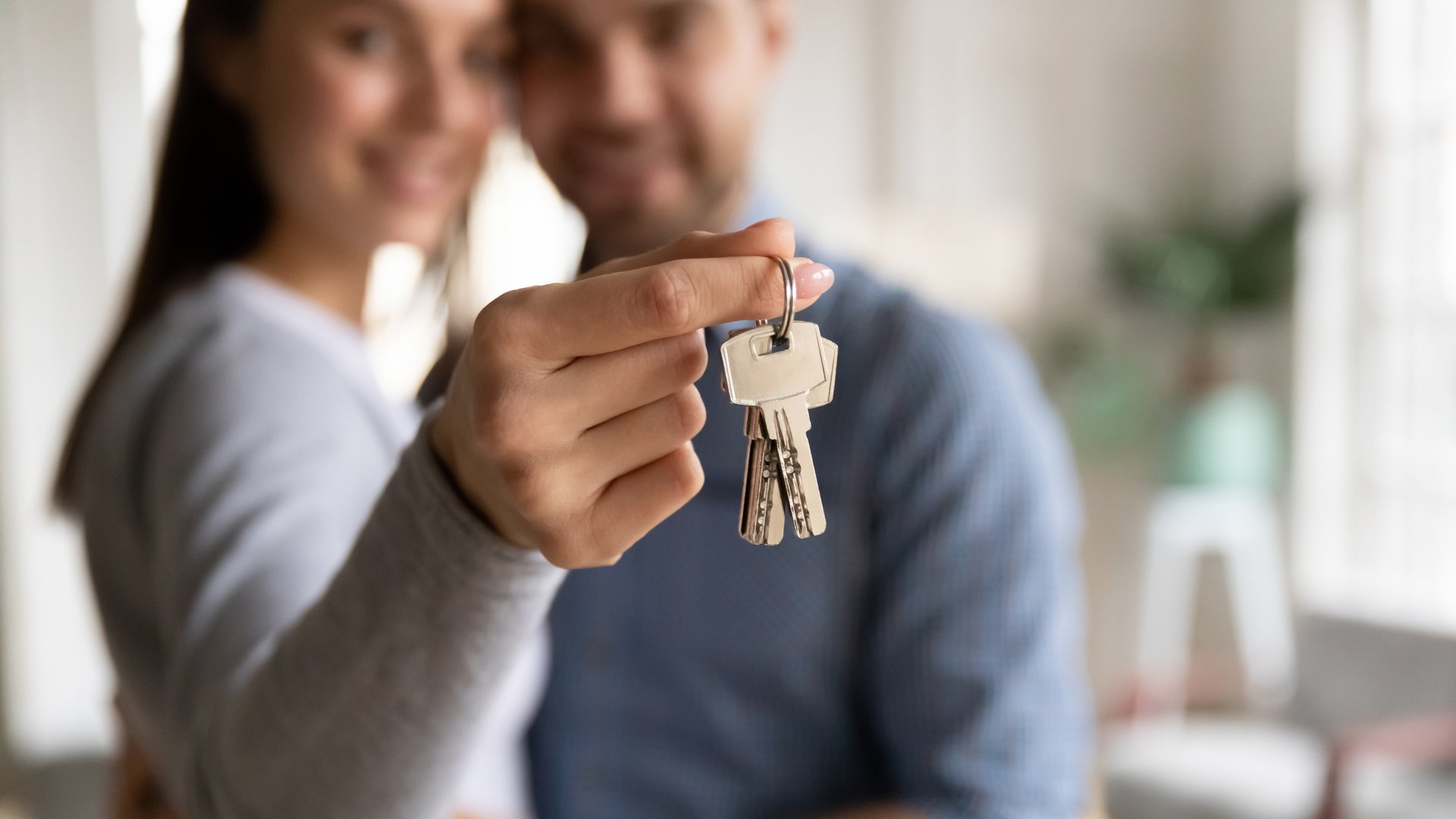 A couple holding the keys to their home